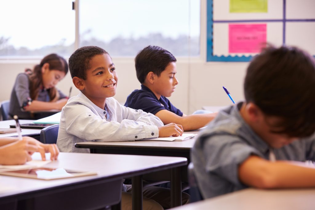 elementary school kids working at their desks.
