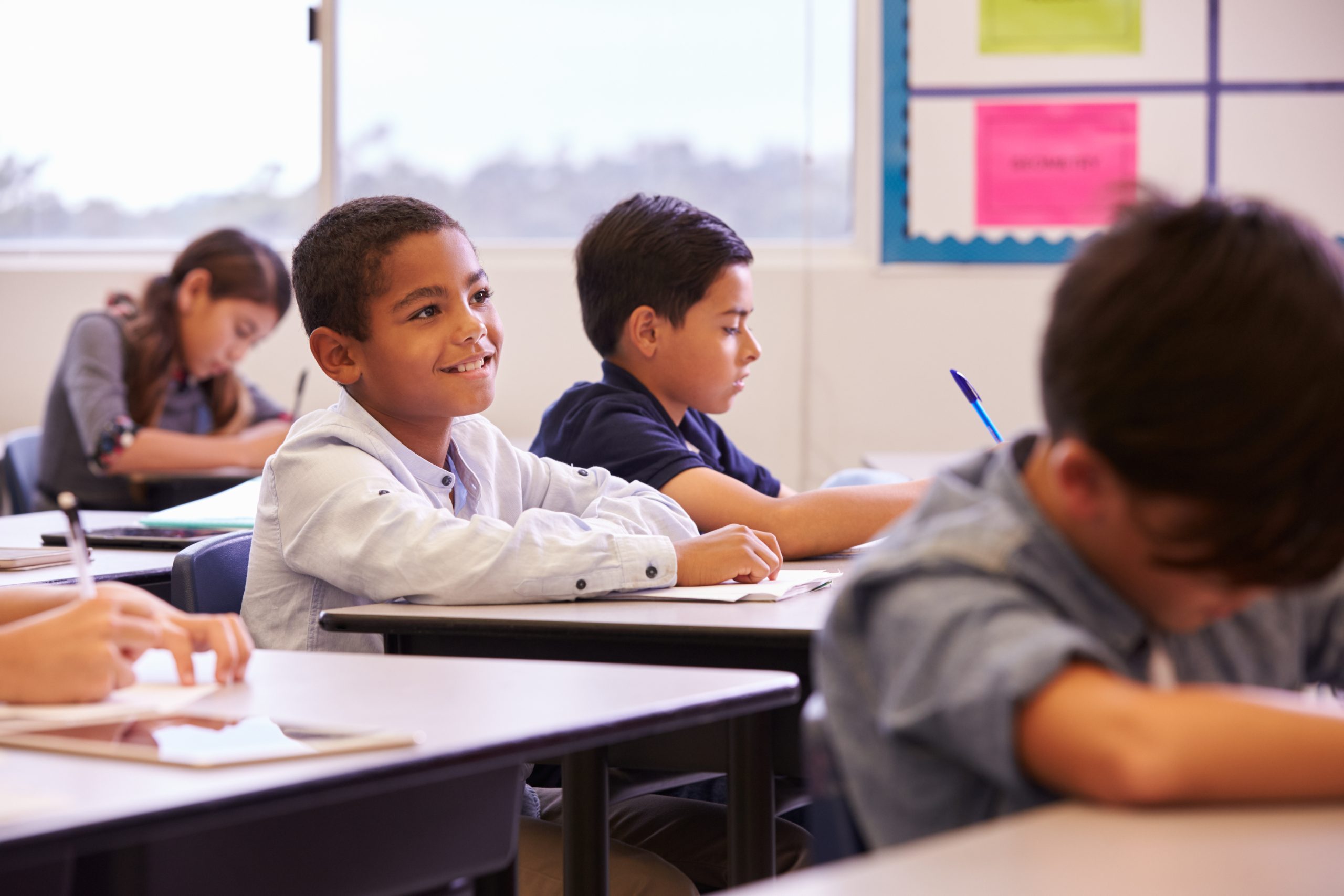 elementary school kids working at their desks.