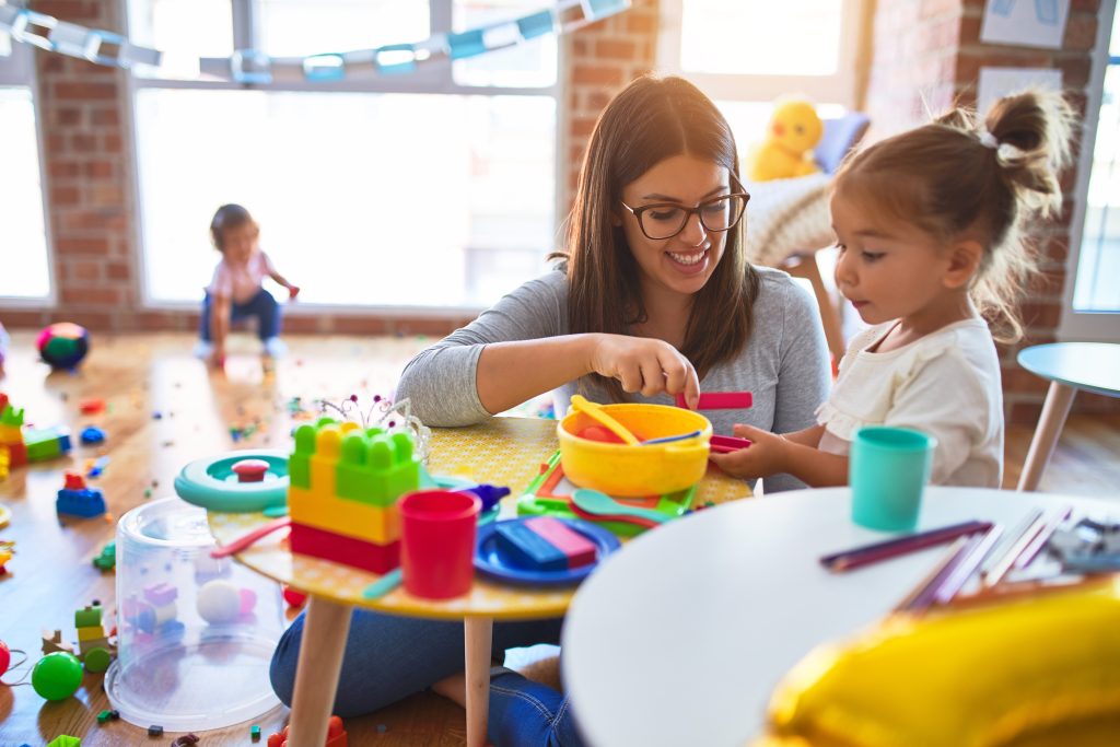 Early childhood professional teaching a toddler.