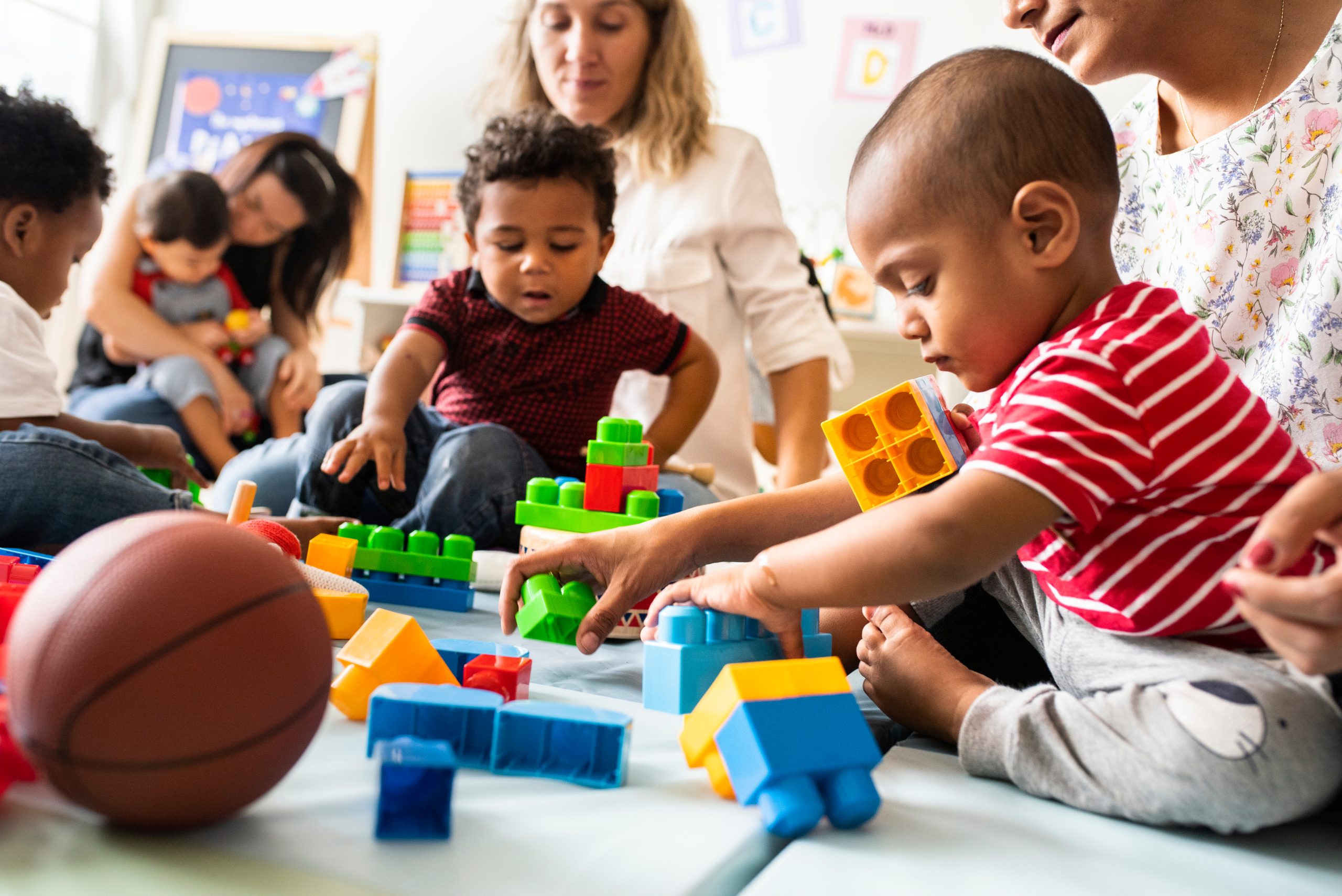 Young children play with blocks in an early childhood classroom.