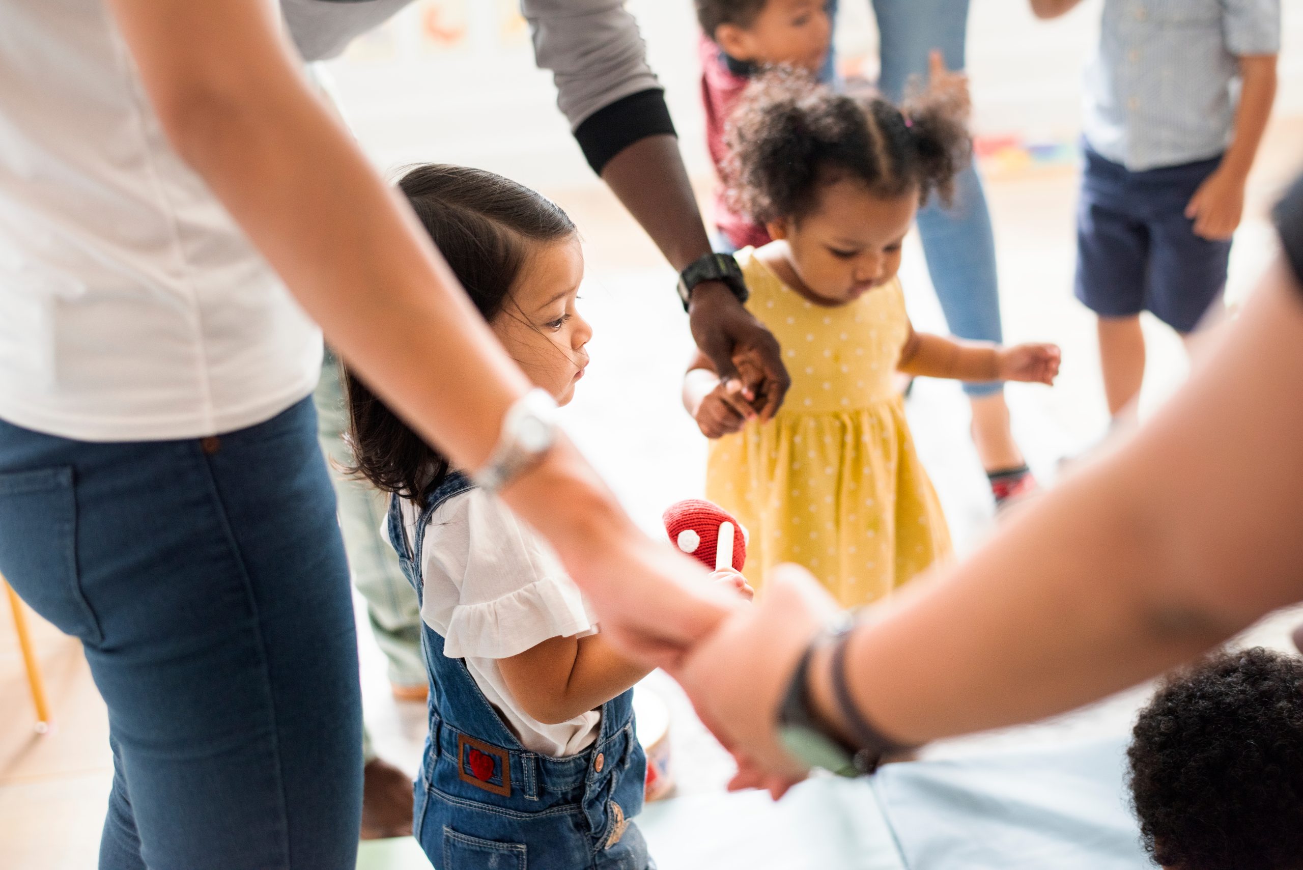 Young,Kids,Standing,With,Their,Parents