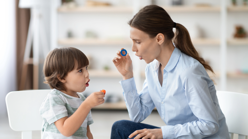 Early childhood educator works on language skills with a young child.