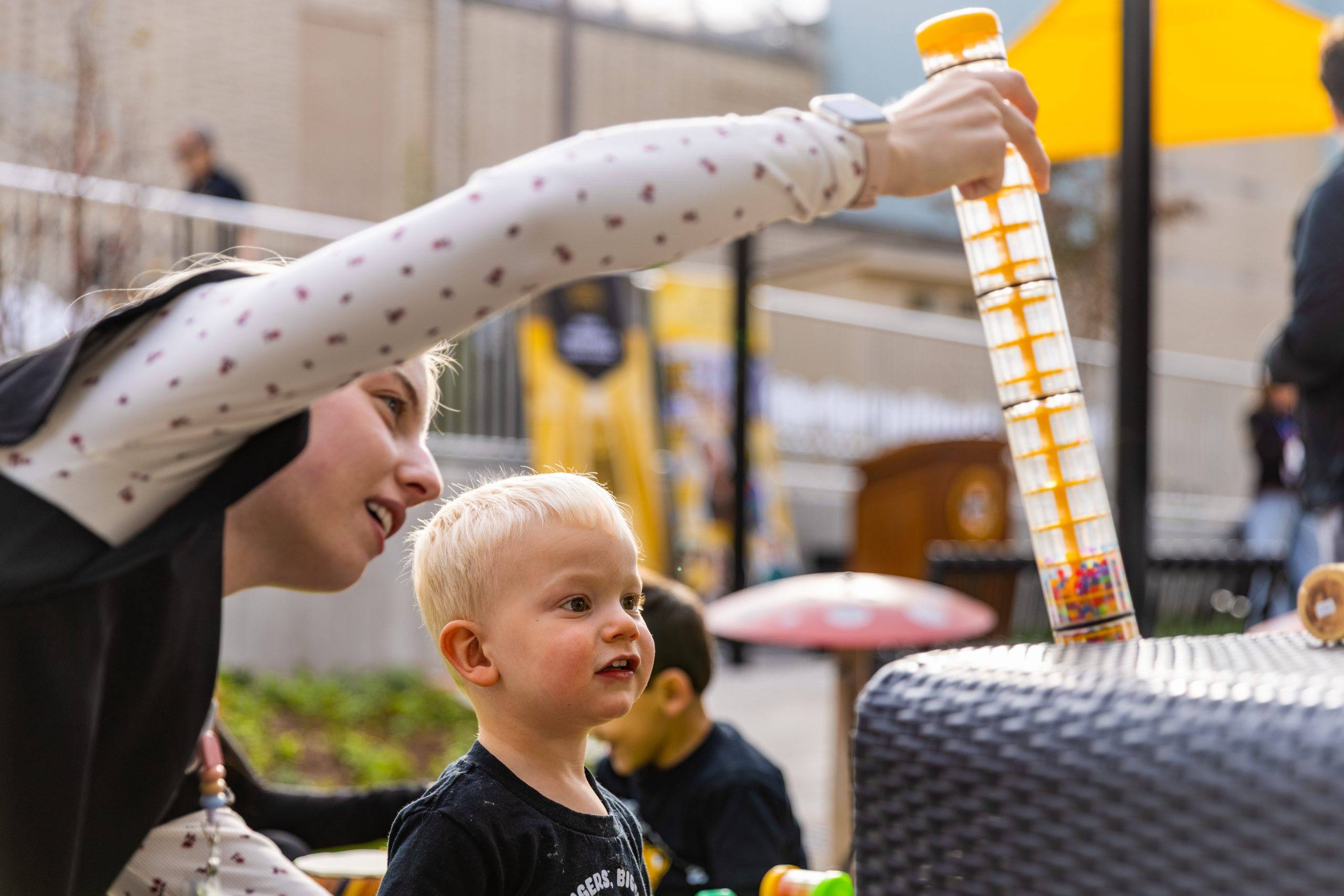 An early childhood professional explores a learning toy with a young child at the CDL.